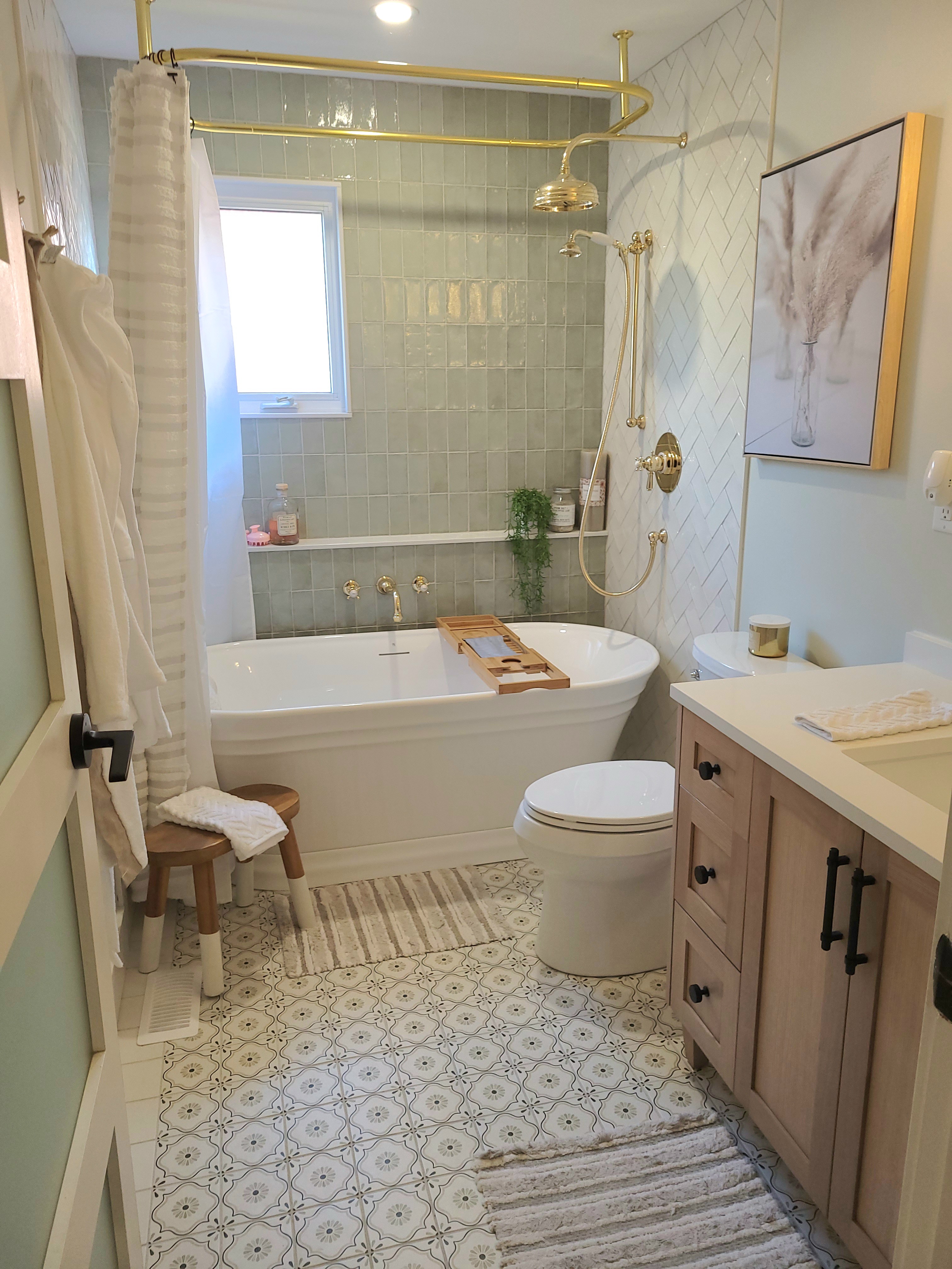 Spa bathroom with sage tiles, gold hardware and freestanding tub