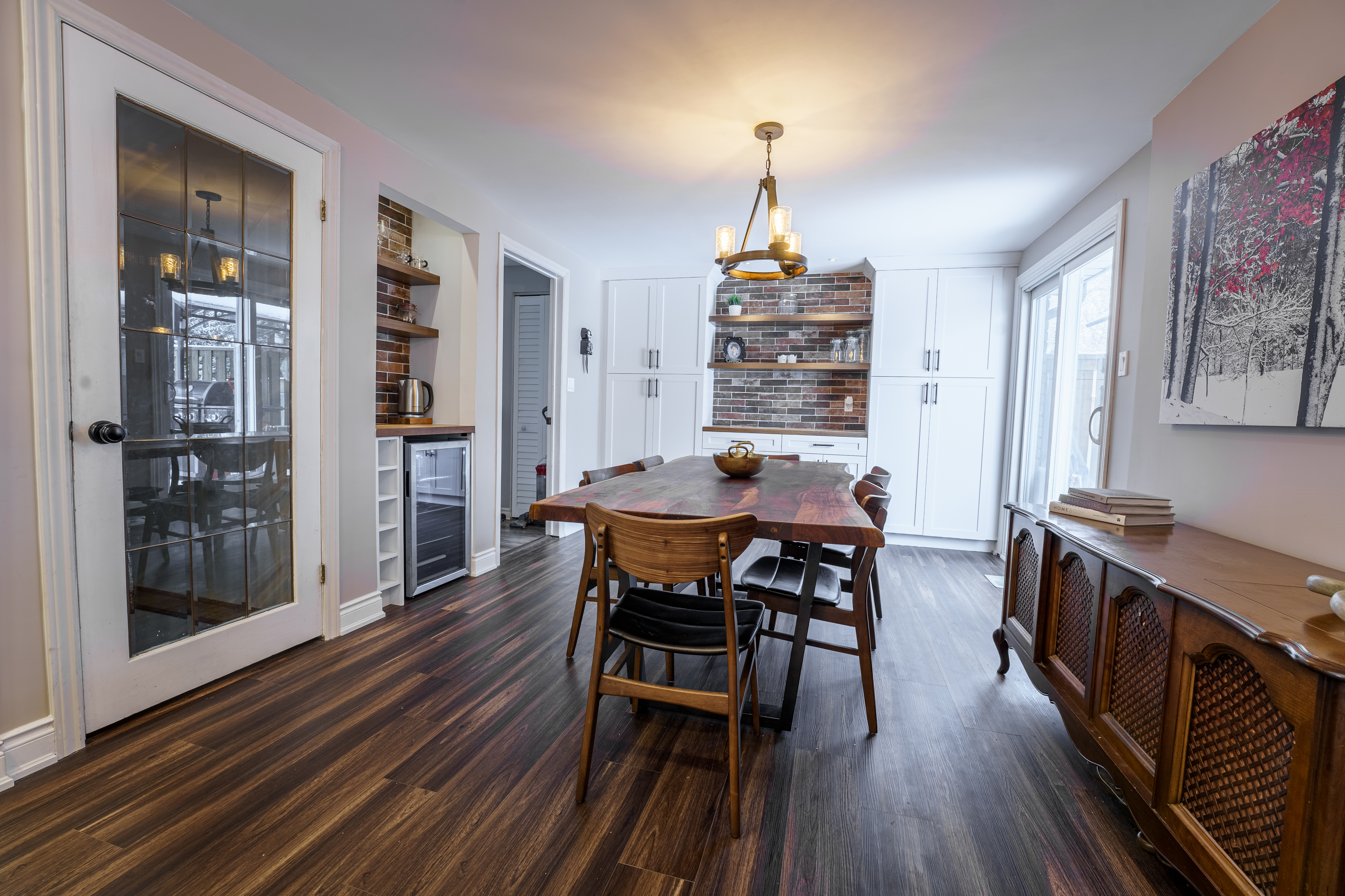 Dining room with wood oval table and built-in shelving